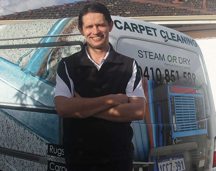Zoran Vukas, owner of Commercial Carpet Cleaning Perth, standing arms folded beside his carpet cleaning van