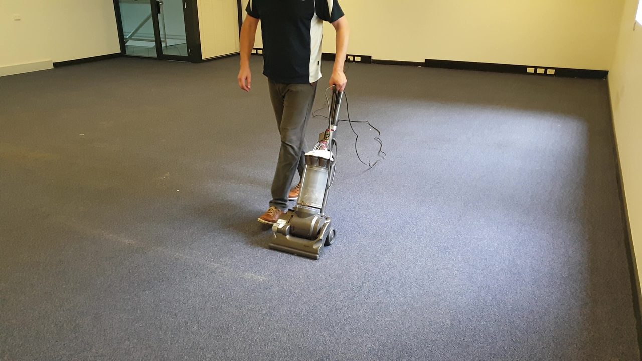 Dry soil vacuumed from dark blue office carpet in Perth, ahead of the winter rains that carry wet soil deep into the building.