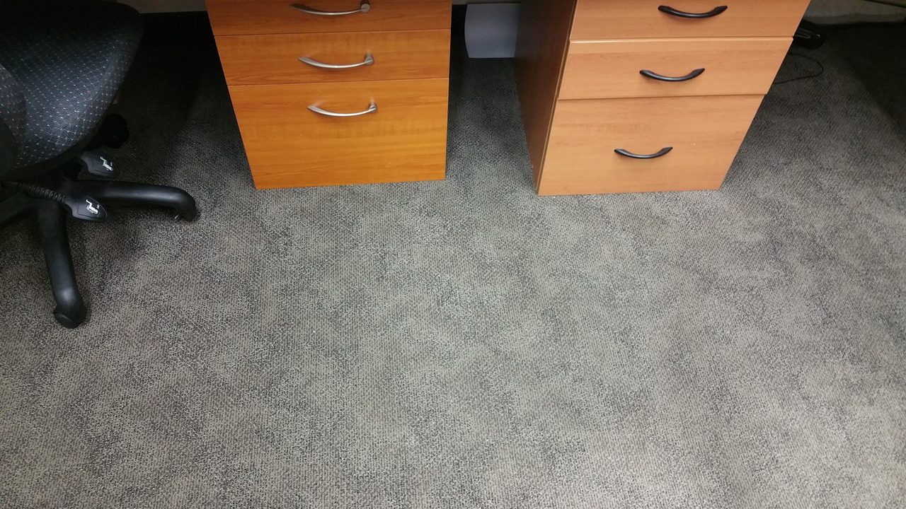 Mottled grey carpet tiles under office workstations in Perth, each clean worth logging for make-good clauses and carpet warranty claims.