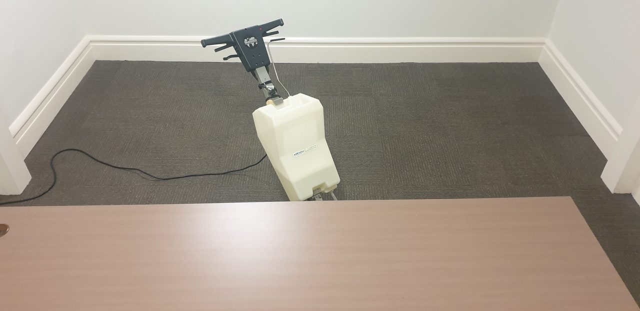 Our scrubbing machine reaching into the corner of a Perth office, where soil collects along the skirting line