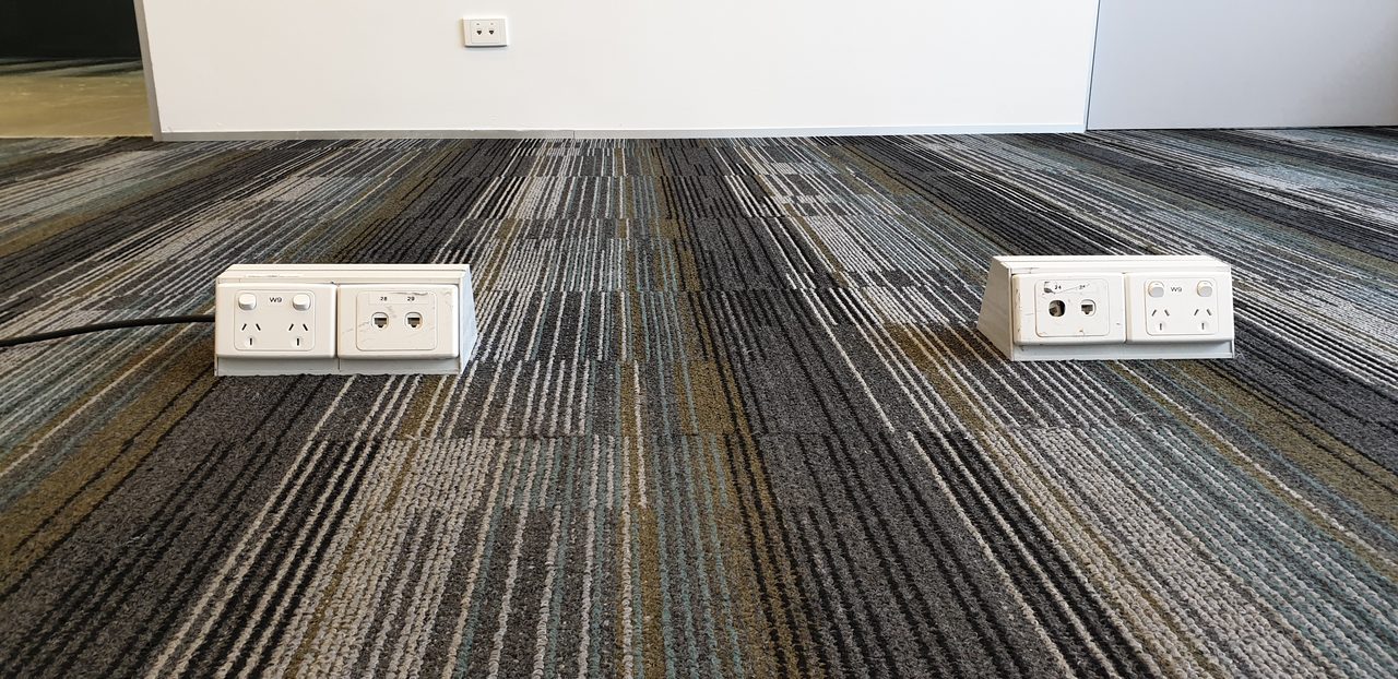 Carpet tiles around the floor outlets of a Perth office, where trapped dust and allergens sit right where staff work