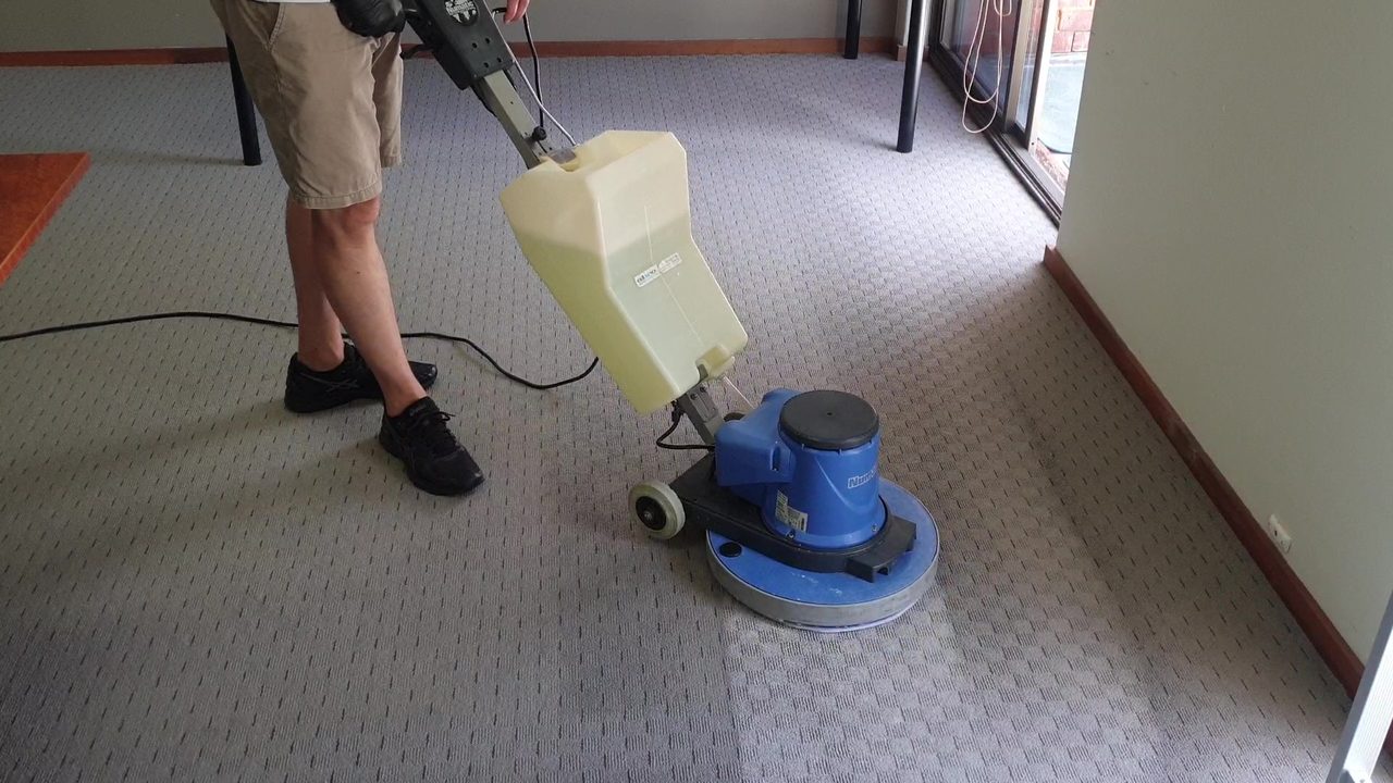 Our rotary machine working low moisture solution into grey patterned carpet in Perth, with products chosen for the fibre and the people using the room.