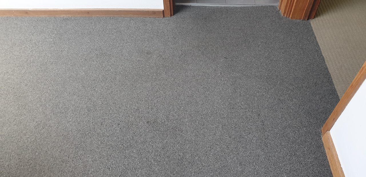 Grey broadloom just inside a tiled Perth entry, the first carpet to catch the sand tracked in from outside