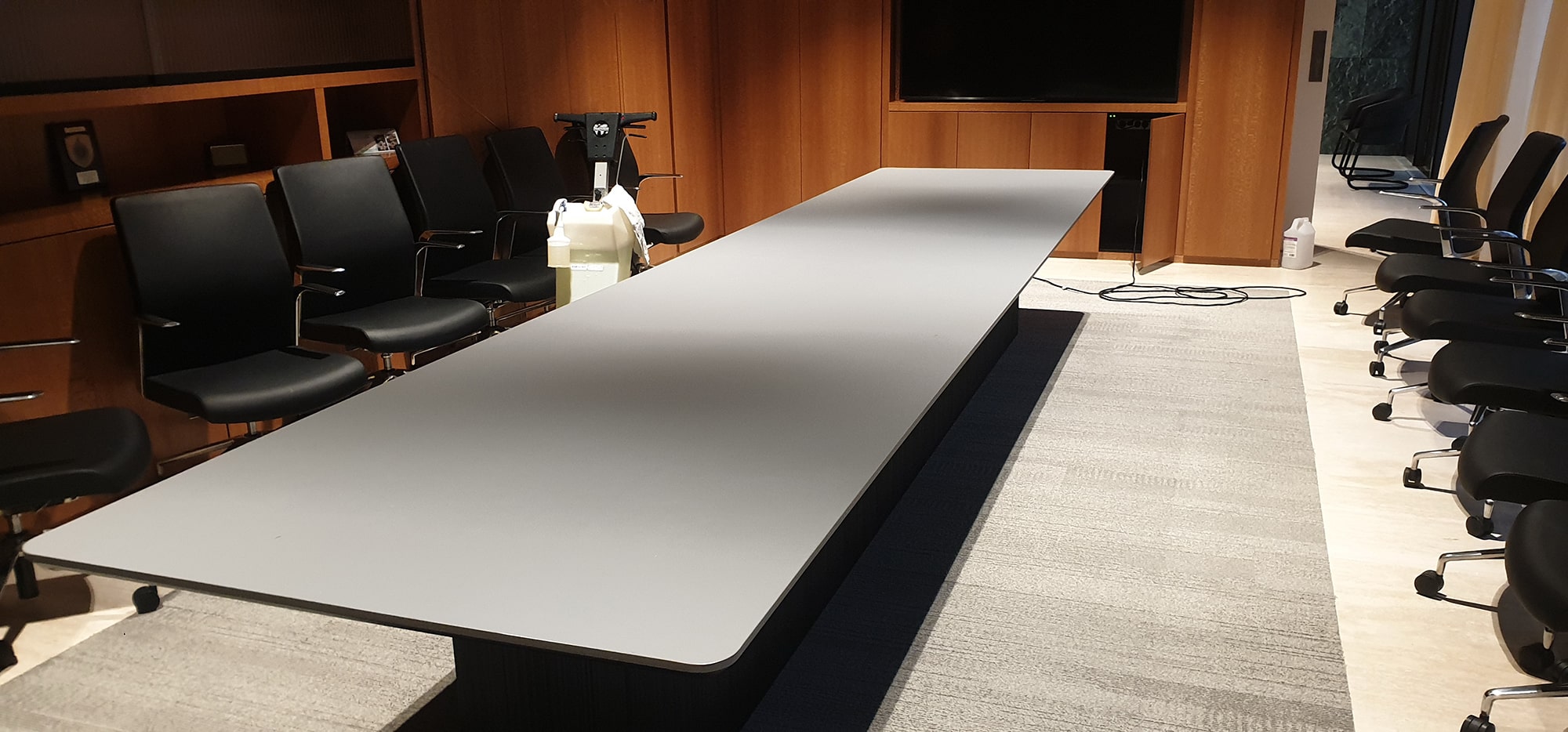 A timber panelled Perth boardroom with its light carpet cleaned around the long table, ready for the next meeting
