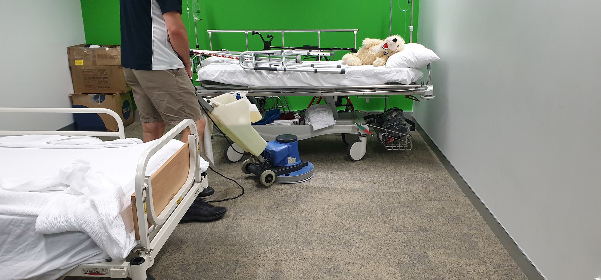 Carpet cleaned between hospital beds in a Perth healthcare facility, where a hygienic floor matters