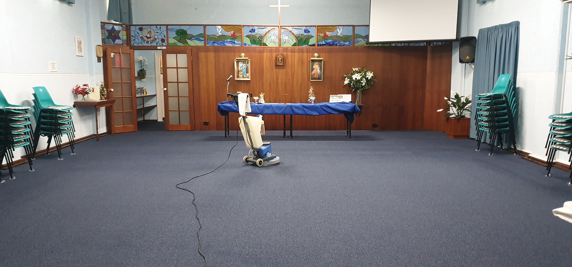 A Perth chapel's blue carpet cleaned with the chairs stacked aside, ready to welcome the congregation back
