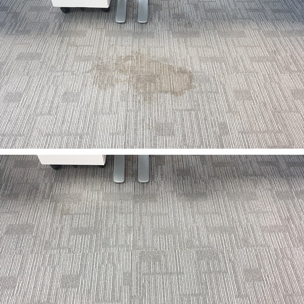 A brown spill stain on light grey patterned carpet tiles in Perth, cleaned out with no ring left in the tile