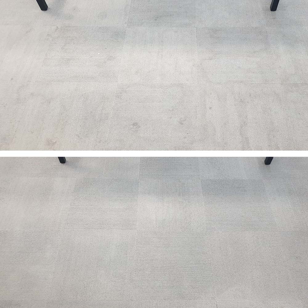 Dark spots and dull soil cleaned from light grey carpet tiles in a Perth office, where every mark shows