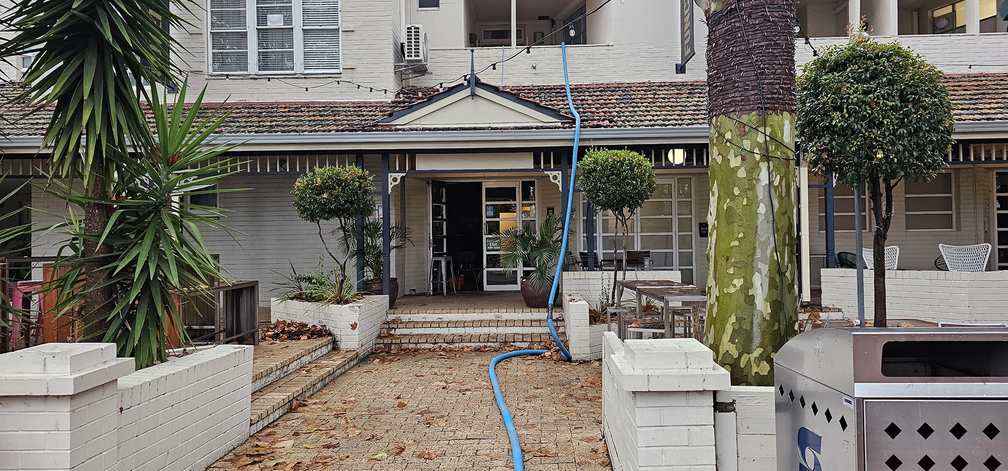 Our truckmount hose run from the van through a Perth courtyard, bringing hot water extraction to the carpet inside
