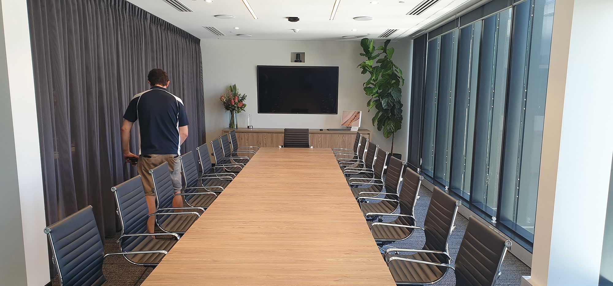 A long Perth boardroom cleaned around its meeting table, the carpet under every chair given the same care
