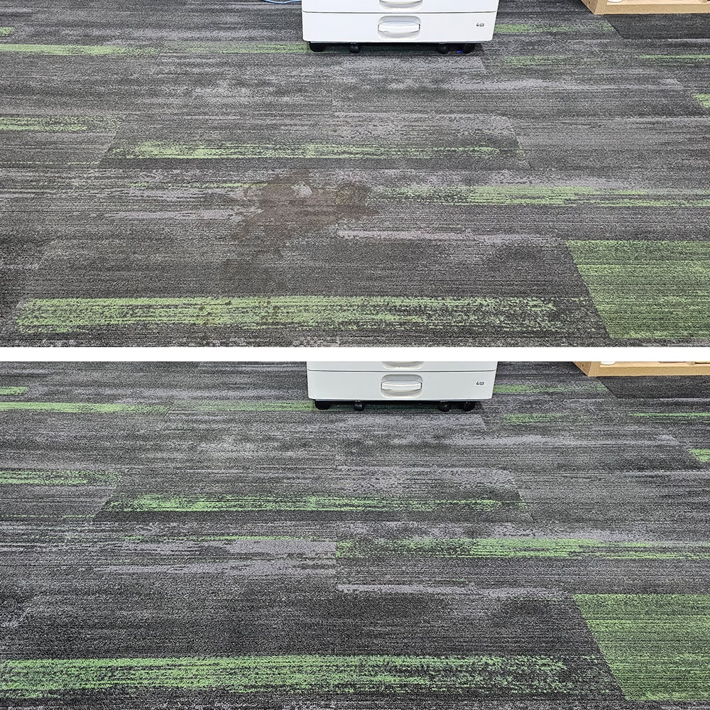 A dark stain on patterned grey and green carpet tiles in Perth, cleaned away to blend with the floor around it
