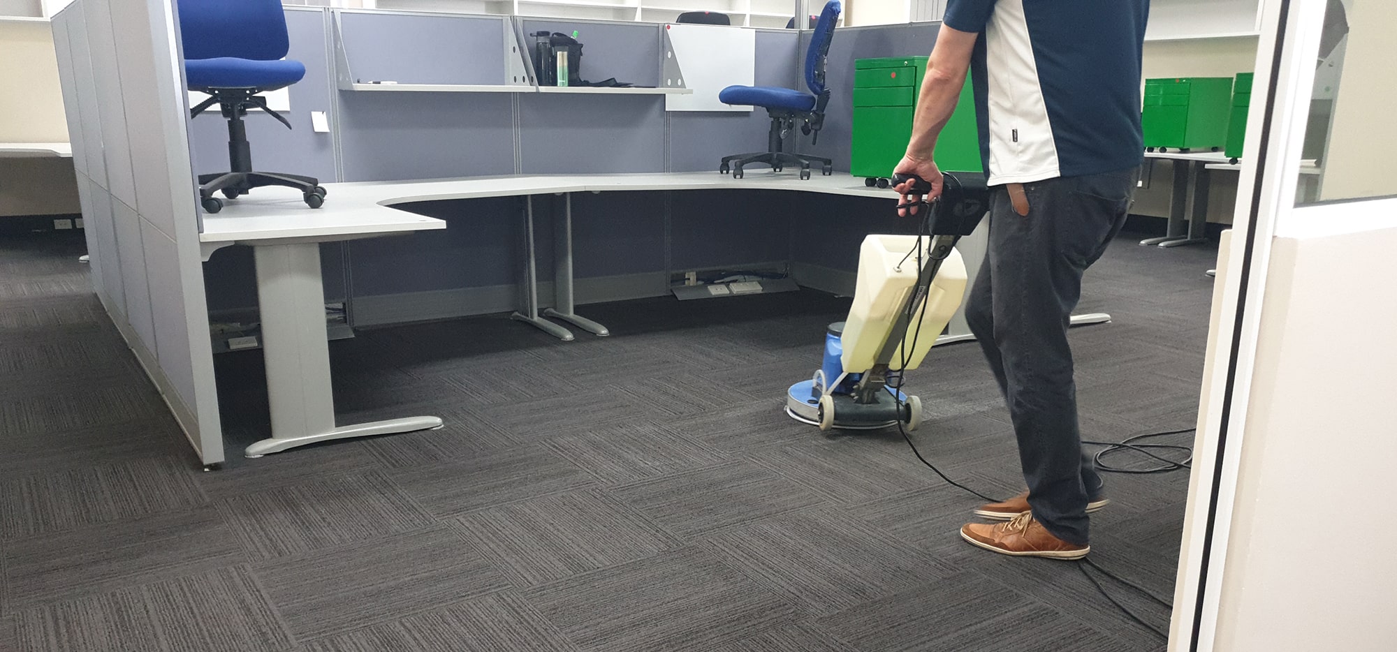 Workstation carpet in a Perth office cleaned between the partitions, the scrubbing machine fitting the narrow gaps