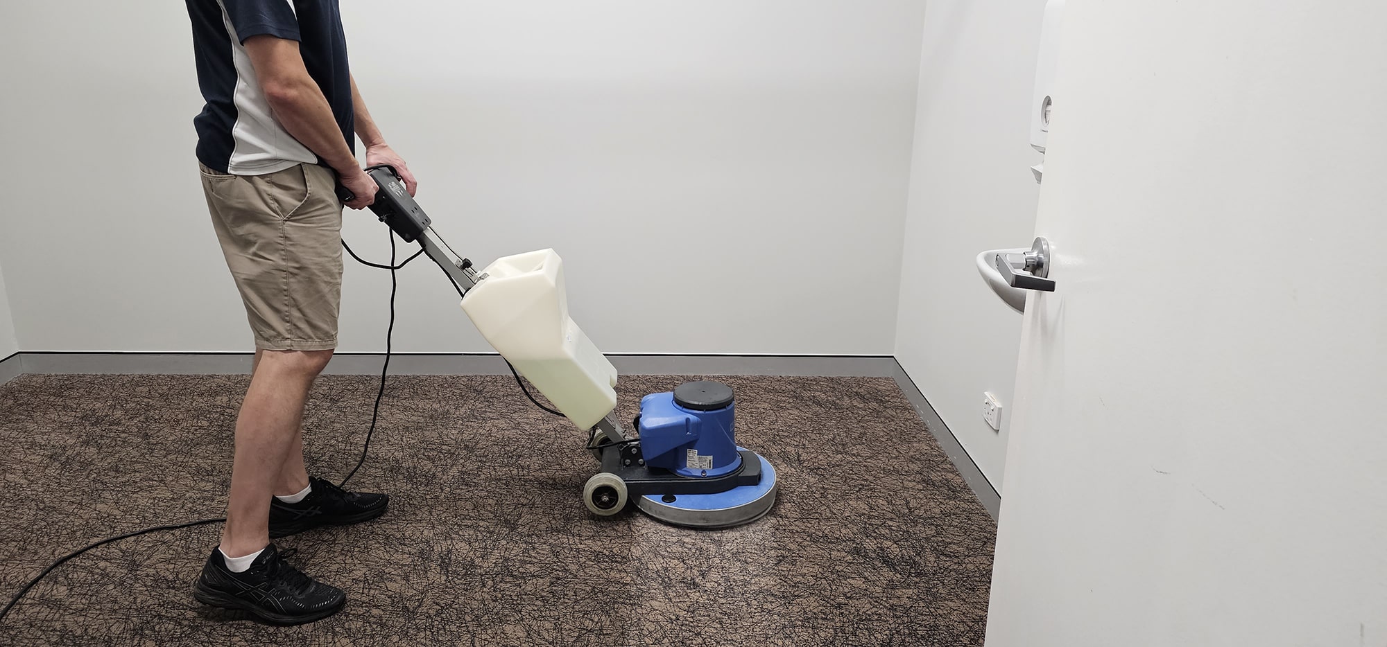 A small Perth office room with patterned carpet scrubbed clean, right into the corners behind the door