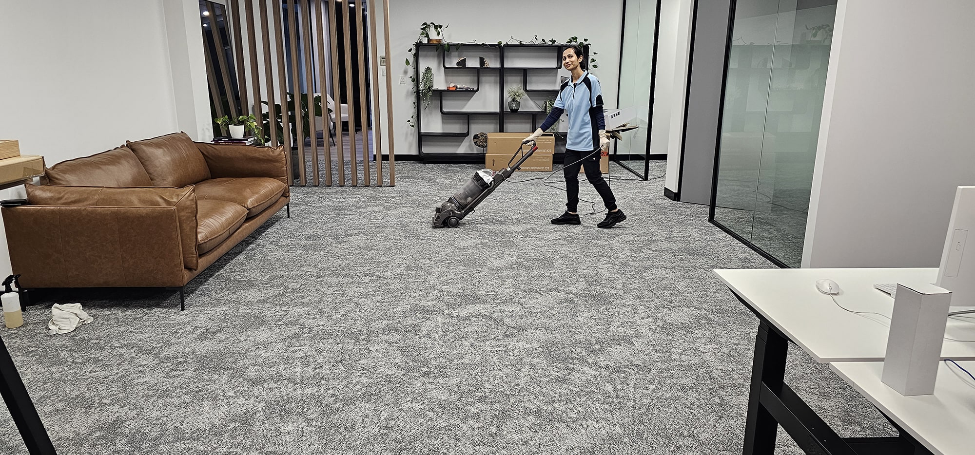Pre-vacuuming a Perth office lounge so the loose soil is out before the carpet clean begins