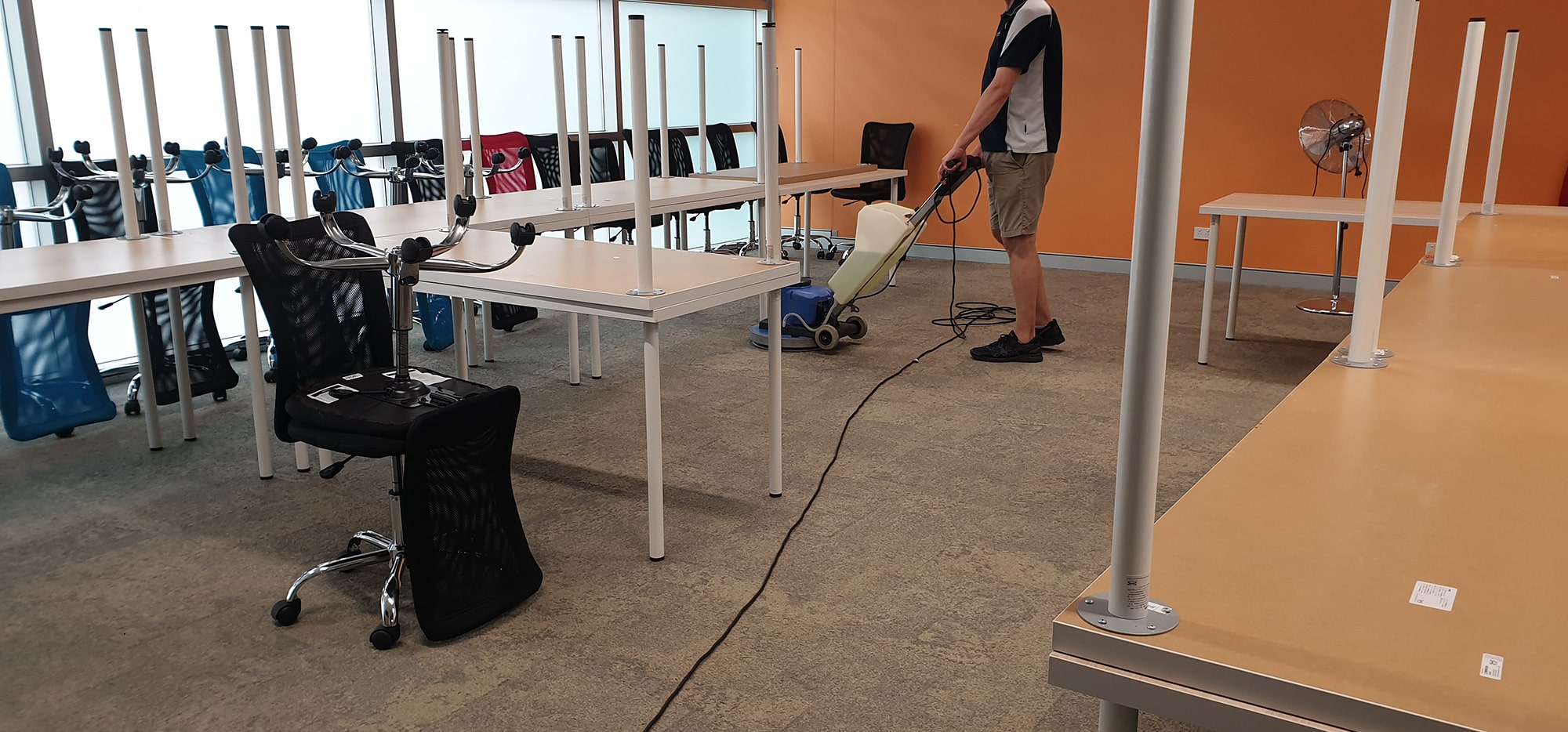 Chairs lifted onto the desks so every metre of carpet on a Perth office floor gets cleaned