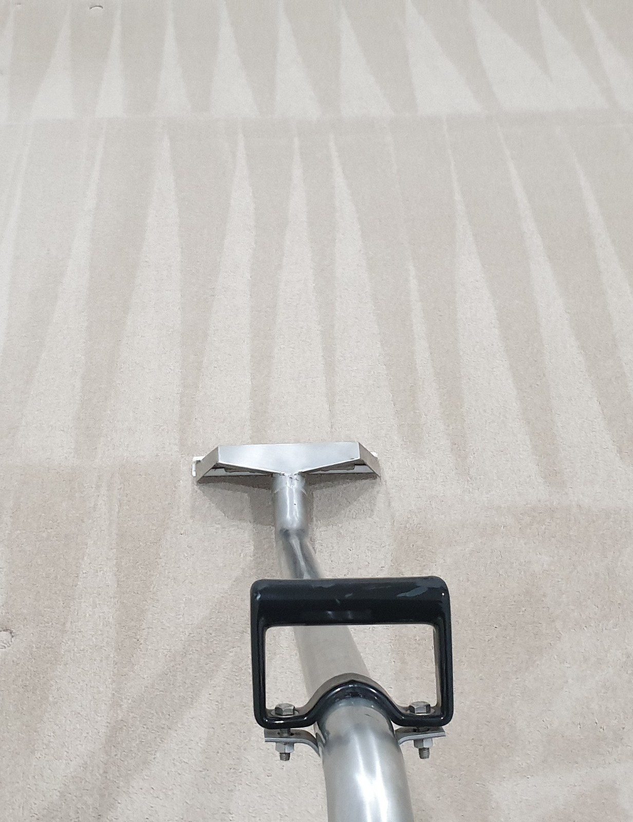 Steam cleaning the carpet of a vacated room in Perth, our extraction wand leaving clean, even rinse stripes across the pile, ready for handover.