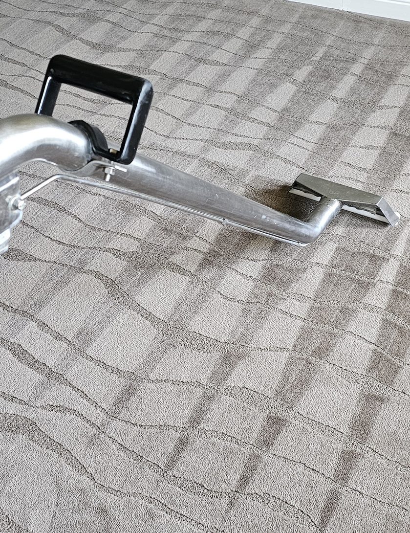 Even rinse stripes from our steam cleaning wand across grey patterned carpet in Perth, the floor left clean and tidy behind us.