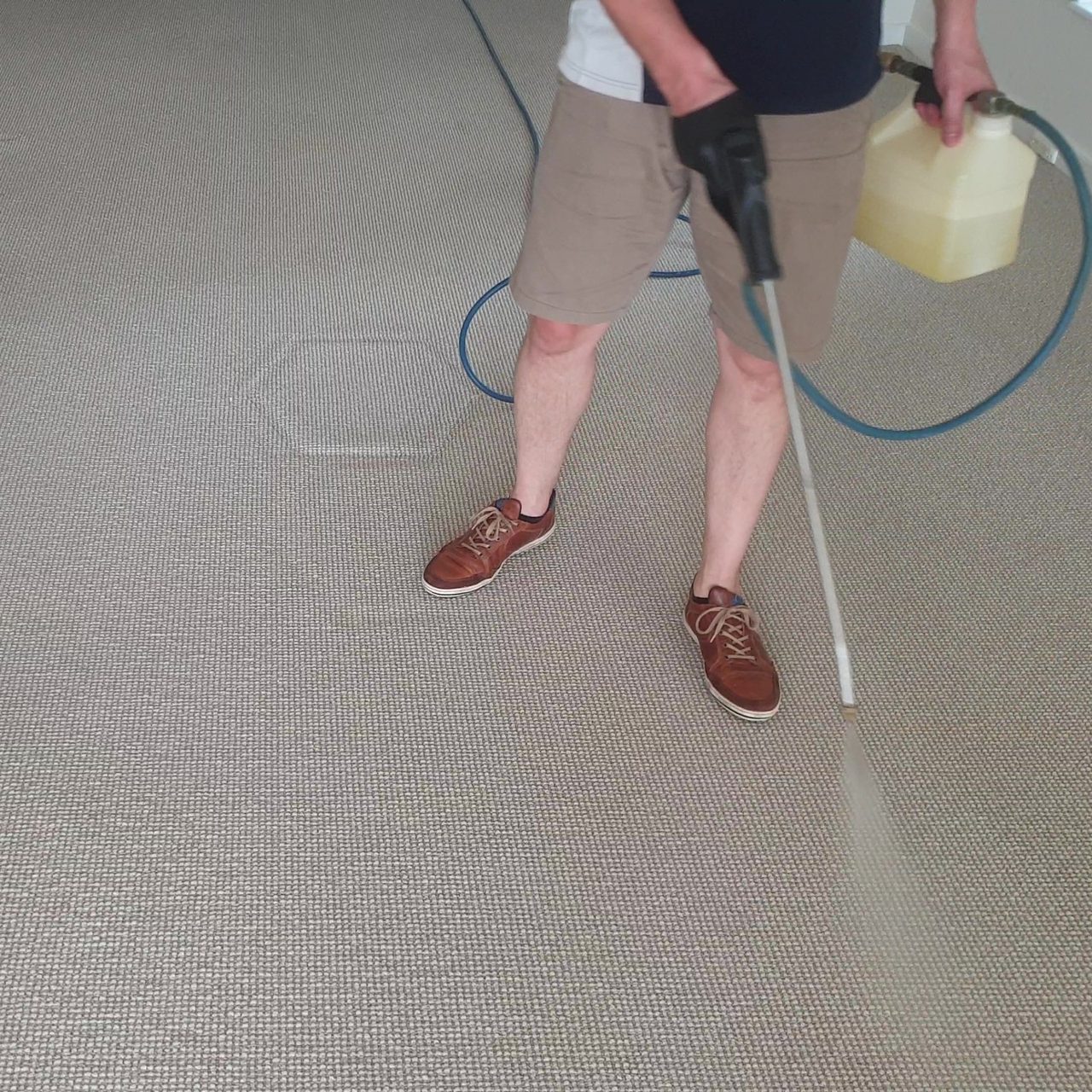 Pre-spray going down on beige carpet in Perth, loosening the soil and the oily film that binds it ahead of the hot water rinse.