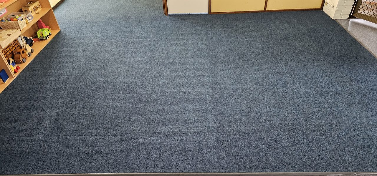 Blue carpet in a Perth childcare room after hot water extraction, fresh wand stripes running across the whole play area.