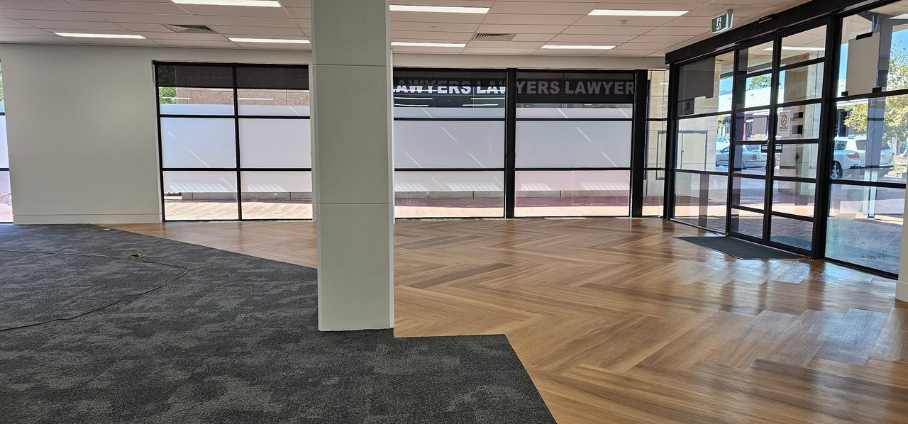 An empty ground-floor tenancy in Perth with its grey carpet tiles cleaned, the make-good work we finish before a lease handover.