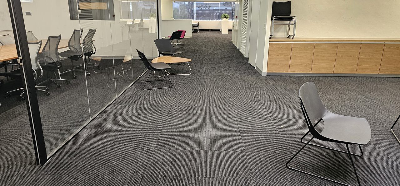 Cleaned charcoal carpet tiles running through a West Perth office with the furniture back in place