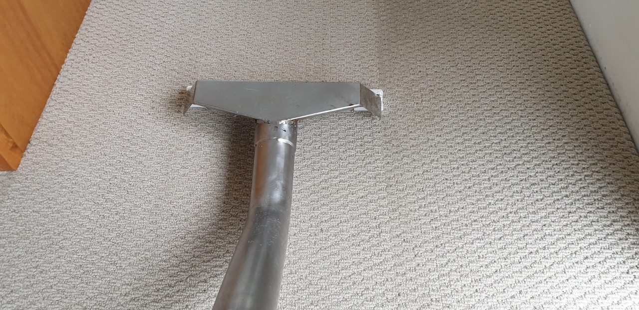 A steam cleaning wand on beige loop-pile carpet, one of three methods we match to your carpet and how soon you need the room.
