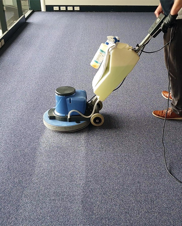 Cleaning carpets in office.
