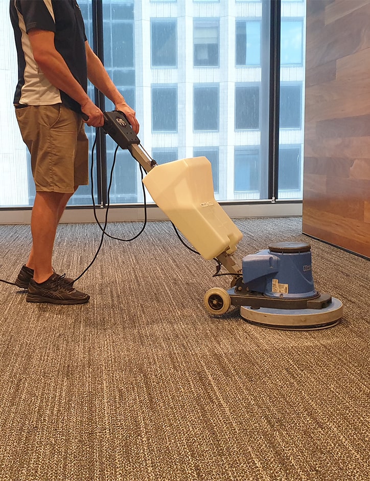 A commercial carpet cleaner cleaning office carpets in Perth city.